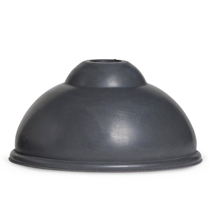 A black, dome-shaped rubber plunger cup with a small opening at the top, placed upside down on a white background.