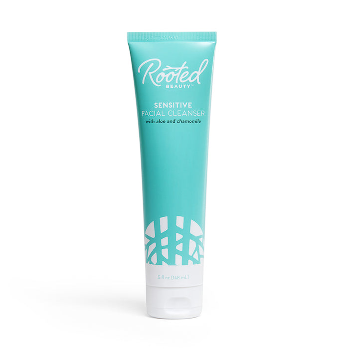 A teal tube of Rooted Beauty Sensitive Facial Cleanser with aloe and chamomile, featuring a rounded white pattern at the bottom and white text on the front. The tube contains 5 fl oz (148 mL) of product.