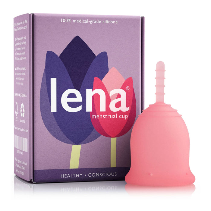 A pink menstrual cup stands upright next to a purple box labeled Lena menstrual cup with abstract flower illustrations and text indicating it’s made of 100% medical-grade silicone.