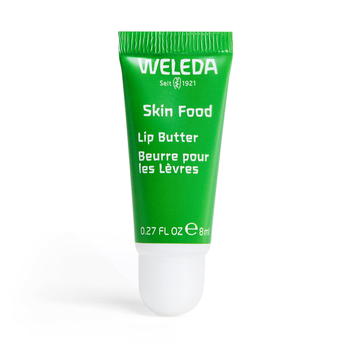 A small green tube of Weleda Skin Food Lip Butter, labeled in English and French, with a white cap and 8 ml (0.27 fl oz) indicated on the front.