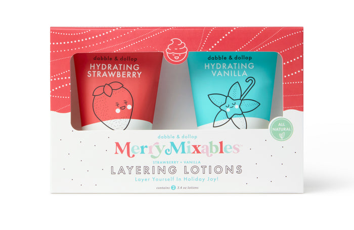 A boxed set of two dabble & dollop Merry Mixables Hydrating Lotions in strawberry and vanilla scents. The packaging is colorful, festive, and features cute illustrations of a strawberry and a vanilla flower.