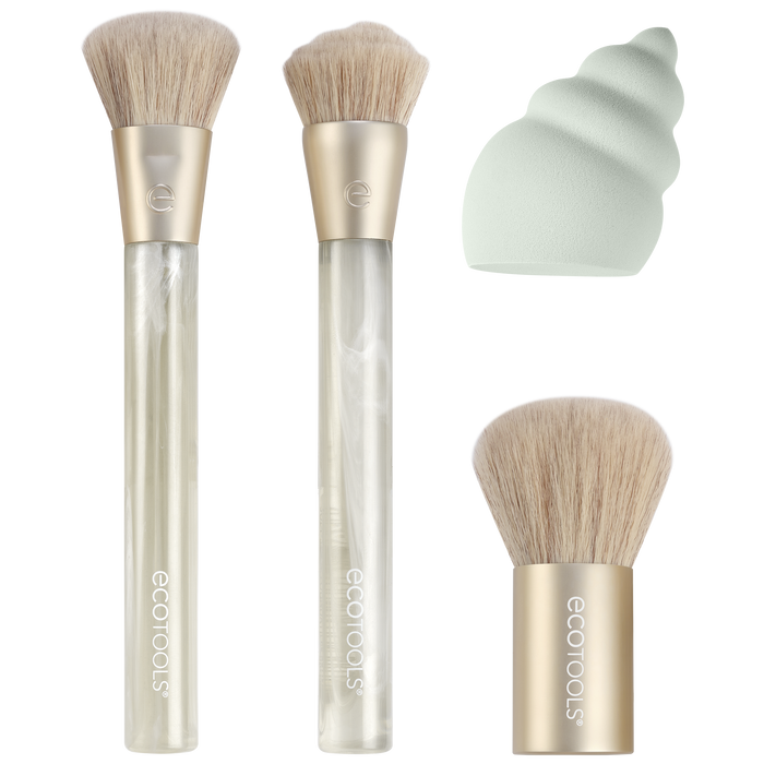 Three makeup brushes with light bristles and gold handles, a mint green spiral makeup sponge, and a short-handled brush are arranged on a white background.