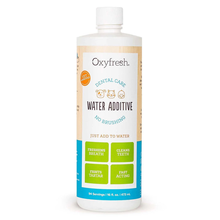 A bottle of Oxyfresh Dental Care Water Additive for pets, with a white cap and a label highlighting benefits like freshens breath, cleans teeth, fights tartar, and fast acting. Designed for no brushing, just add to water.