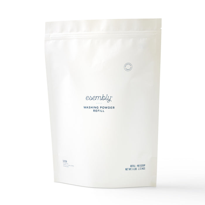 A white, resealable pouch labeled Esembly Washing Powder Refill with minimalist blue text. The package stands upright against a plain white background.
