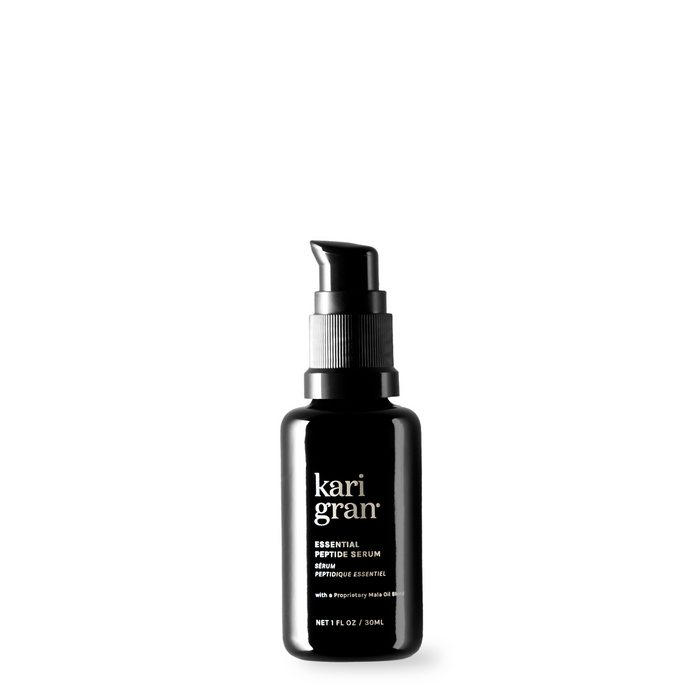 A black pump bottle labeled kari gran Essential Peptide Serum with white text, displayed against a plain white background. The bottle contains 1 fl oz (30 ml) of product.