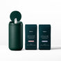An open dark green cylindrical container with wipes is next to two Biom-branded dark green packages labeled All-Purpose Wipe Refills, featuring 100% plant-based cleaning wipes, ideal for surfaces and skin, combining eco-friendliness with efficiency.