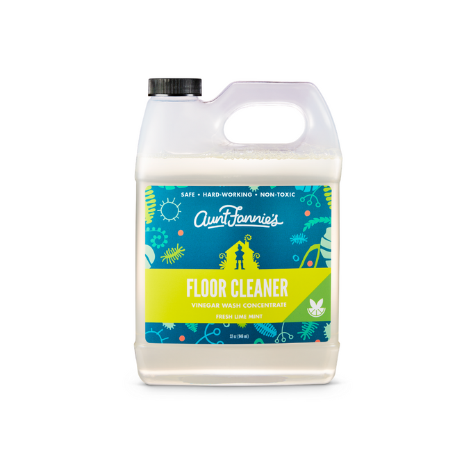 Aunt Fannies Multi-Surface Floor Cleaner comes in a 1-gallon jug with a decorative blue and green floral-citrus label. The Fresh Lime Mint vinegar wash concentrate features plant-based surfactants and a stylish black cap, boasting Vinegar Powered cleaning thats safe and non-toxic.