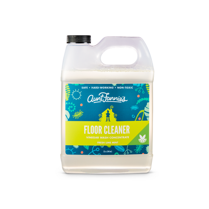 Aunt Fannies Multi-Surface Floor Cleaner comes in a 1-gallon jug with a decorative blue and green floral-citrus label. The Fresh Lime Mint vinegar wash concentrate features plant-based surfactants and a stylish black cap, boasting Vinegar Powered cleaning thats safe and non-toxic.