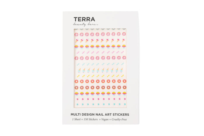 A white package labeled Terra beauty bars displays a sheet of colorful nail art stickers with various designs, including donuts, ice cream cones, and hearts. Text at the bottom notes 1 sheet, 150 stickers, vegan, and cruelty-free.