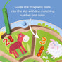 The HABA Number Maze Magnetic Game for ages 2+ features numbered sections with animal illustrations. Red magnetic balls fill section 3 with a sheep, a green wand rests nearby, and simple instructions make it an engaging toddler STEM toy.