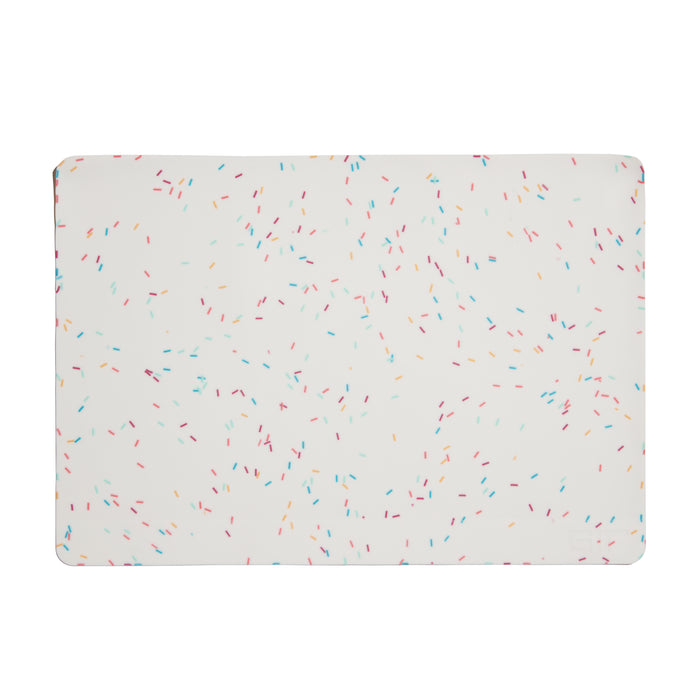 A rectangular white mat with rounded corners, decorated with small, scattered, multicolored sprinkle-like dashes.