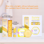 A display of citrus-themed body care products, including a choco body scrub mini, butter spread lip balm, lotion bar, and a sunny citrus trial kit, arranged on a light wooden surface with a promotional message above.