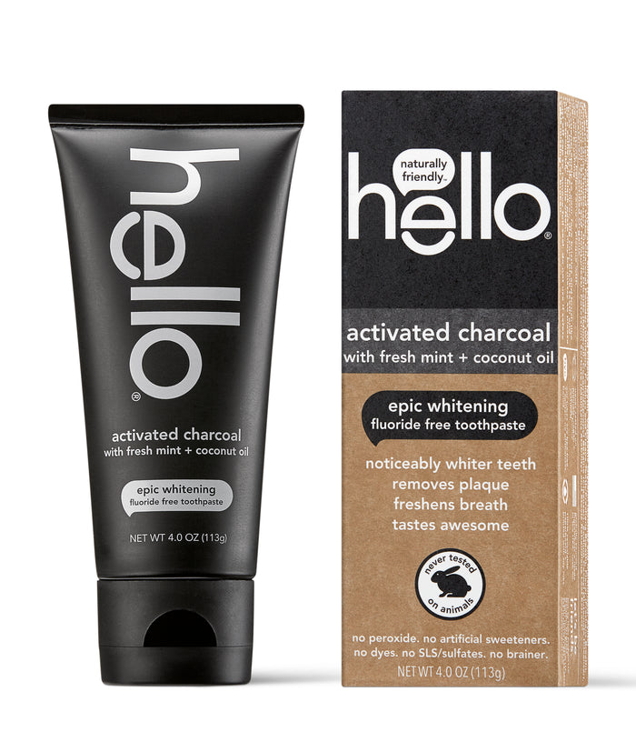 A black tube and a brown box of Hello activated charcoal fluoride-free toothpaste with fresh mint and coconut oil, featuring epic whitening and claims of whitening teeth, removing plaque, and freshening breath.