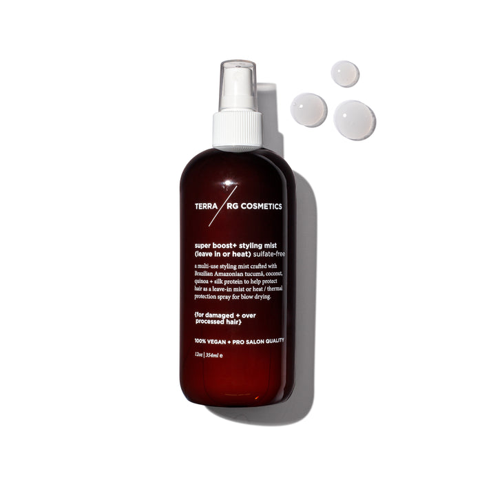 A brown spray bottle labeled “TERRARIG COSMETICS super boost+ styling mist” sits on a white background with three drops of clear liquid nearby. The bottle features white text and a white spray nozzle.