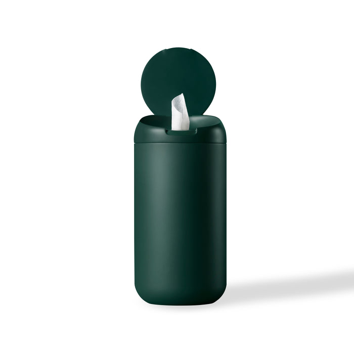 A dark green cylindrical container with a flip-top lid, slightly open to reveal a single white wipe being dispensed, set against a plain white background.