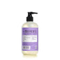 A Mrs. Meyers Hand Soap bottle features a lavender label with garden-inspired scents and a black pump, highlighting natural ingredients and essential oils. Recycling symbols on the back promote environmental care.