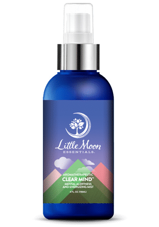 A blue spray bottle labeled Little Moon Essentials Clear Mind Aromatherapeutic Mist, featuring a white tree logo and colorful mountain graphics on the label.