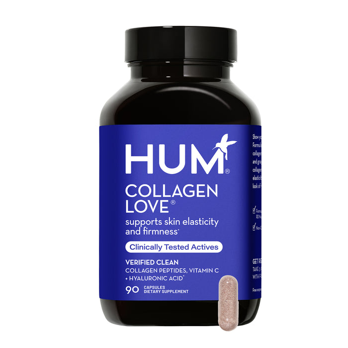 A bottle of HUM Collagen Love supplements with a blue label, showing product details and a single beige capsule placed in front of the bottle. The label states benefits for skin elasticity and firmness.