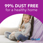 A young girl with long brown hair smiles on a couch, cuddling a fluffy gray cat. Text above reads 99% dust free for a healthy home with okocat Low Tracking Clumping Wood Cat Litter. The okocat logo appears in the lower right corner.