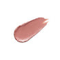 A smooth, oval-shaped smear of shimmery, light pink makeup, likely lipstick or lip gloss, on a white background.