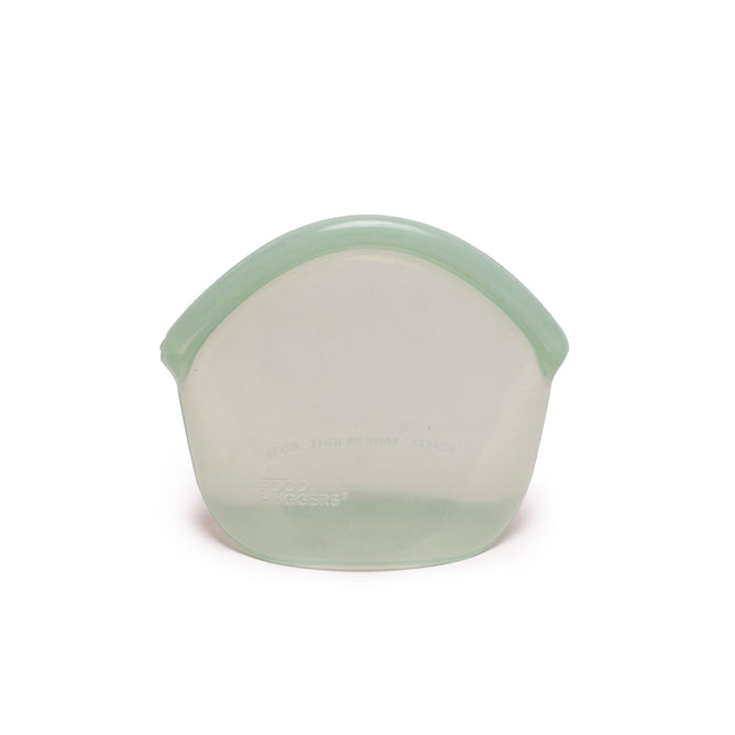 A Hugger Bag from Food Huggers is shown against a plain white background. Its a translucent green silicone food storage bag with a rounded top and flat base, dishwasher safe, easy to clean, and stylish for everyday use.
