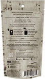 Back of a Grab Green laundry detergent pods package displays usage instructions, ingredients, transparency message, certifications, barcode, and company information. Text highlights are in black on a brown, wood-textured background.