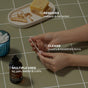 Hands using Cliganic Organic Cotton Swabs on a tiled surface, with jewelry, a hair clip, soap, and a bottle nearby. Text highlights: removes makeup & nail polish, cleans jewelry, and offers multiple uses for pets, babies & crafts.