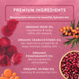 A pink skincare graphic highlights Badger Balm’s Rose Beauty Oil - Restores & Smooths, featuring premium biocompatible ingredients: organic rose oil, seabuckthorn oil, pomegranate oil, and jojoba oil to naturally nourish and care for your skin. The design includes images of rose petals, seabuckthorn berries, and pomegranate seeds set against a soft pink background.
