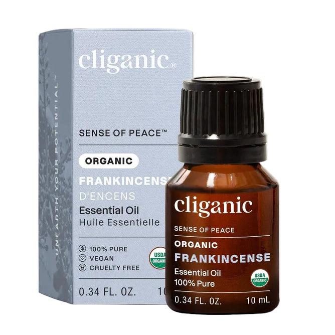 A 10 ml bottle of Cliganic Organic Frankincense Essential Oil - Sense of Peace is displayed in front of its box, featuring labels for 100% pure, vegan, cruelty-free, and USDA organic. This essential oil offers a grounding aroma ideal for your aromatherapy rituals.