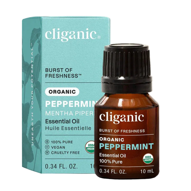 A 10ml bottle of Cliganic Organic Peppermint Essential Oil - Burst of Freshness is displayed in front of its blue and brown box. The labels highlight that it is 100% pure, vegan, cruelty-free, and USDA organic certified, emphasizing the invigorating cooling mint aroma and soothing benefits of this premium peppermint oil.