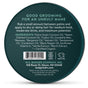 Round tin labeled ORGANIC HAIR POMADE TIN - STYLE & SHINE by Badger Balm, featuring a list of natural ingredients, medium hold description, usage instructions, company information, and a cruelty-free logo—all set against a dark green background—an organic hair product crafted for effortless styling.