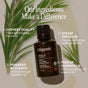A bottle of Cliganic Organic Tea Tree Essential Oil - Boost of Clarity rests on a beige background adorned with palm leaves. The text emphasizes its premium quality, steam-distilled extraction process, plant-based formula, and chemical-free composition. Highlighted for its natural mosquito-repellent properties, this tea tree essential oil is ideal for organic aromatherapy routines.