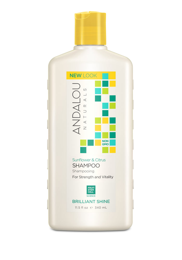 A white bottle of Andalou Naturals Sunflower & Citrus Shampoo, labeled Brilliant Shine, with colorful squares and text highlighting NEW LOOK, Non GMO, and Fruit Stem Cell Science. The bottle holds 11.5 fl oz (340 ml).