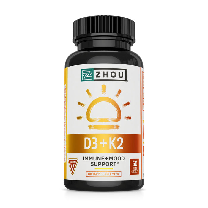 A black bottle of Zhou D3 + K2 dietary supplement with a yellow and orange label featuring a sun graphic; the label indicates it supports immune and mood health and contains 60 vegetable capsules.