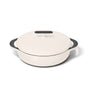 A white round Dutch oven with a matching lid and two black handles sits on a white background.