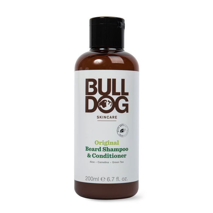 A brown plastic bottle of Bulldog Skincare Original Beard Shampoo & Conditioner with a black cap. The white label features the Bulldog logo and product details in brown and green text. The bottle size is 200ml (6.7 fl oz).