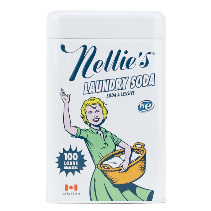 A white canister of Nellie’s Laundry Soda features a retro illustration of a smiling woman in a green dress holding a laundry basket. The label notes 100 loads and displays a small Canadian flag.