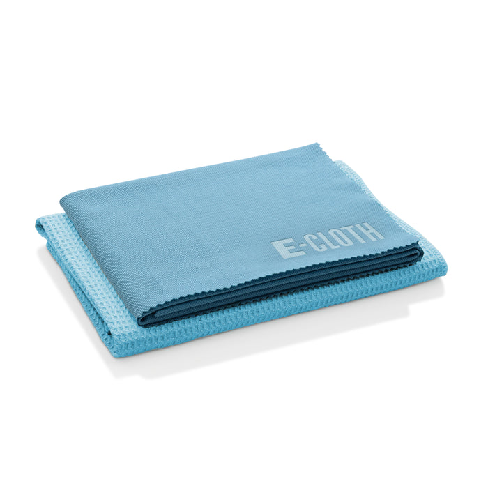 Two folded blue cleaning cloths stacked on top of each other, with the top cloth labeled E-CLOTH in white text.