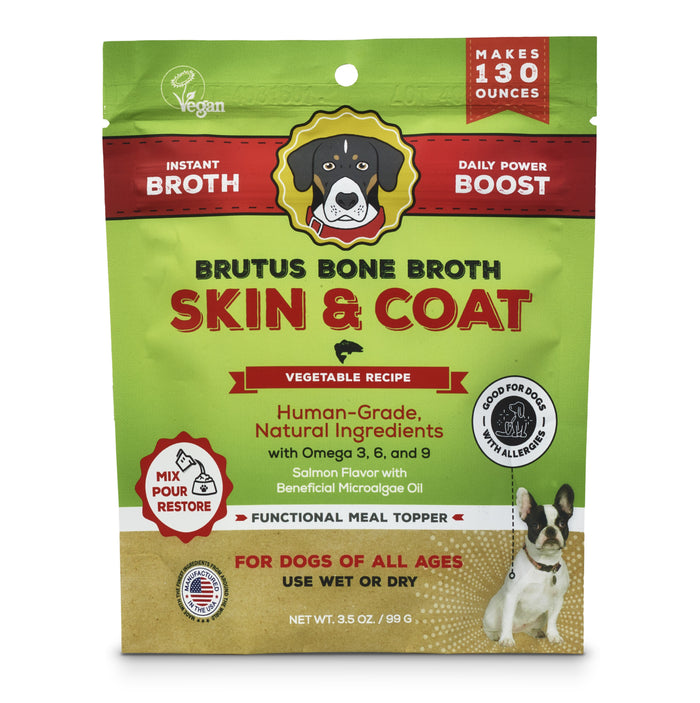 The green package of Brutus on the Go: Vegetable Skin & Coat Instant Bone Broth Mega Pack by Brutus Broth features a charming dog illustration. The labels highlight its vegan, plant-based broth, human-grade quality, enriched with Omega 3, 6, 9 for pet skin and coat health, in delicious salmon flavor. Perfect as a meal topper or treat!.