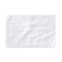 The Shag Organic Bath Rug by Coyuchi, a fluffy white rectangular bath mat made from organic cotton, is displayed on a plain white background, highlighting its soft and textured surface.