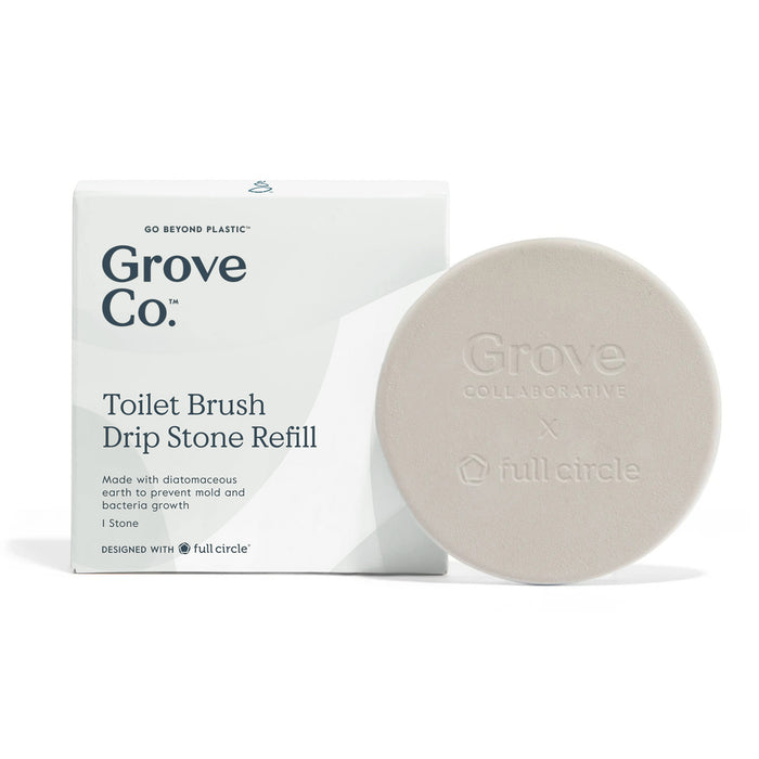 A white box labeled Grove Co. Toilet Brush Drip Stone Refill next to a round, beige stone embossed with Grove Collaborative x full circle. The box notes it is made with diatomaceous earth to prevent mold and bacteria.