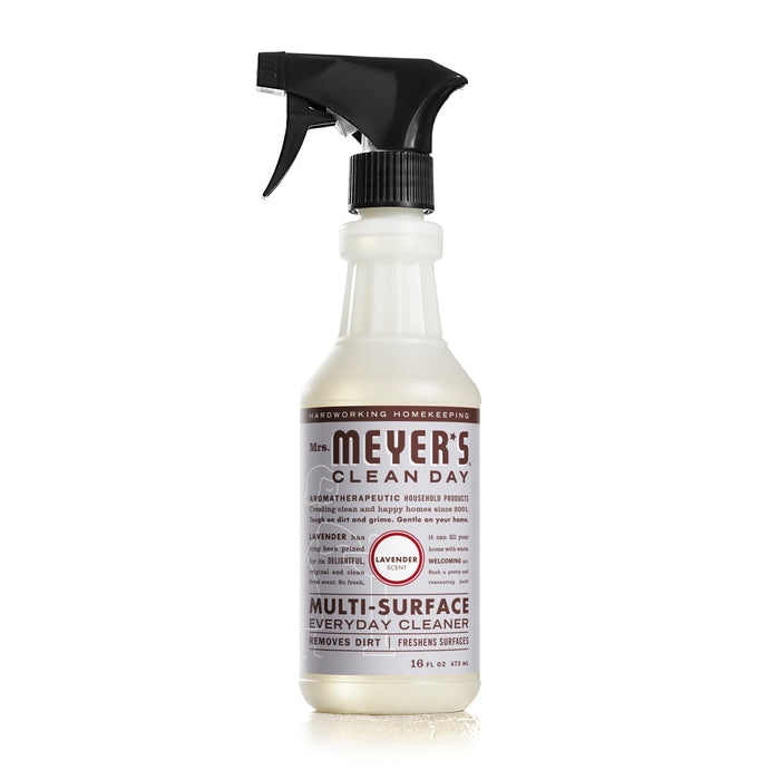 A bottle of Mrs. Meyers Clean Day Multi-Surface Everyday Cleaner in lavender scent with a black spray nozzle, standing upright against a white background.