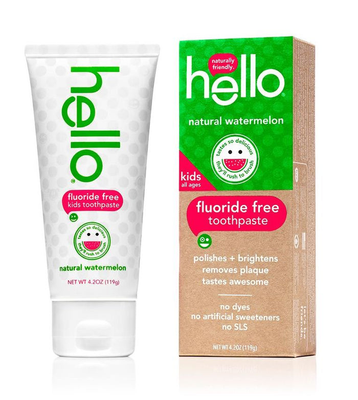 A tube and box of Hello fluoride-free kids toothpaste in natural watermelon flavor, featuring green, white, and red design elements and a smiling watermelon graphic. Text highlights that its dye free and has no artificial sweeteners.
