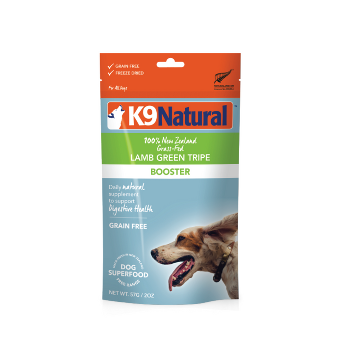 A package of K9 Natural Lamb Green Tripe Booster dog food, labeled grain free and freeze dried, features an image of a running dog and highlights benefits for digestive health.