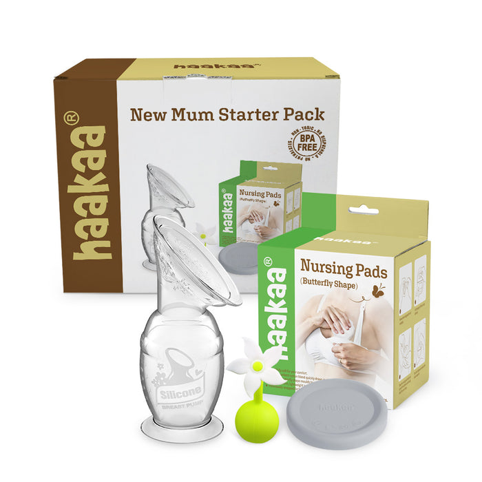 Haakaa New Mum Starter Pack with a brown and white box, a clear silicone breast pump, a gray lid, a green flower stopper, and a green box of butterfly-shaped nursing pads with an image of a hand holding a pad.