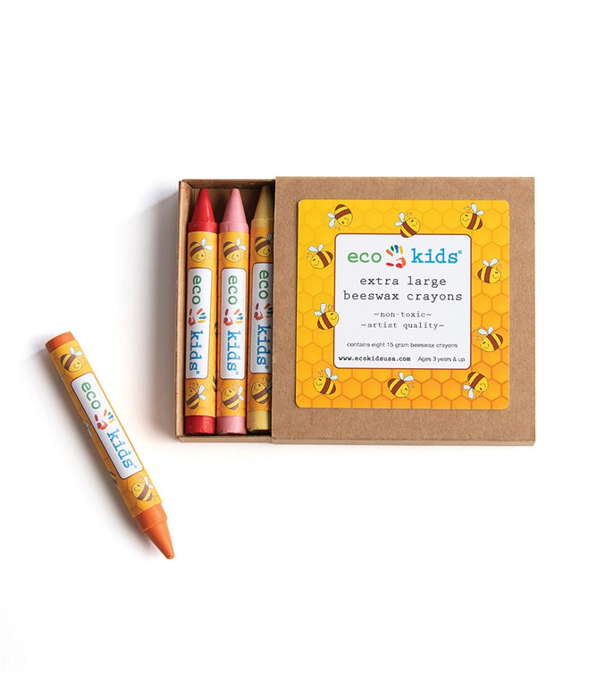 An open box of Elseware Unplug Beeswax Crayons shows four vibrant, extra-large, non-toxic crayons (red, pink, yellow, orange) with bee designs and one orange crayon beside the box on a white background.