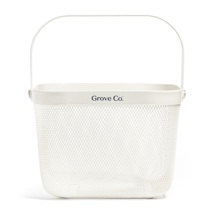 A white metal mesh basket with a rectangular shape, rounded edges, a sturdy handle, and Grove Co. printed on the front.