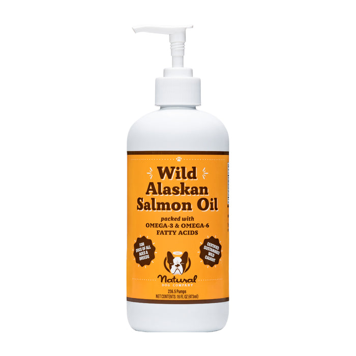 A white bottle with a pump labeled Wild Alaskan Salmon Oil, featuring orange and brown colors, claims to be packed with omega-3 and omega-6 fatty acids and depicts a cartoon animal face on the label.