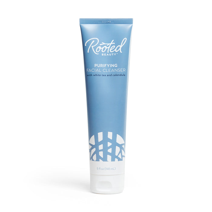 A blue tube labeled Rooted Beauty Purifying Facial Cleanser with white tea and calendula, containing 5 fl oz (148 mL), standing upright on a white background.