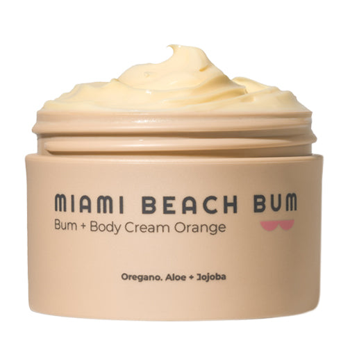 A beige jar labeled Miami Beach Bum Bum + Body Cream Orange with creamy, pale yellow lotion swirled on top. The label also lists Oregano, Aloe + Jojoba as key ingredients.